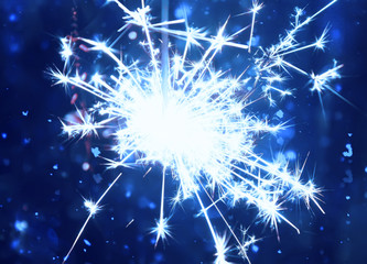 Bengali fire. Festive firework bright salute burst. Festive new year blurred glitter colorful background.