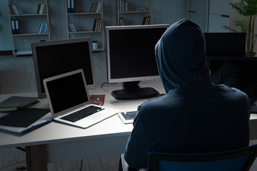 Hacker hacking computer at night