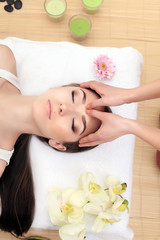 Obraz na płótnie Canvas Spa relaxation, skincare, healthy pleasure concept. Woman lying with closed eyes having relaxing face massage