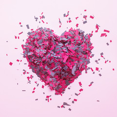Confetti in heart shape decoration on colorful background.Love concepts.flat lay