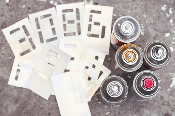 five spray cans with stencil numbers
