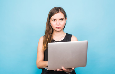 Smart beautiful young woman using laptop pc computer isolated on blue background