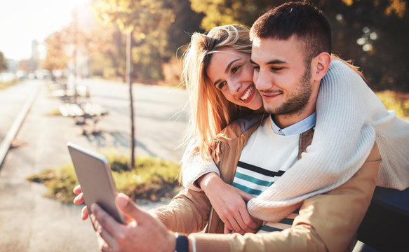 Young smiling couple enjoying in meeting and have fun with tablet. Dating, love and tenderness, lifestyle concept