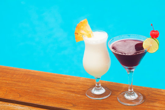 two delicous cocktails by the pool