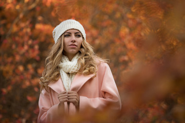 Woman enjoying autumn day, she walking in park, colorful foliage around