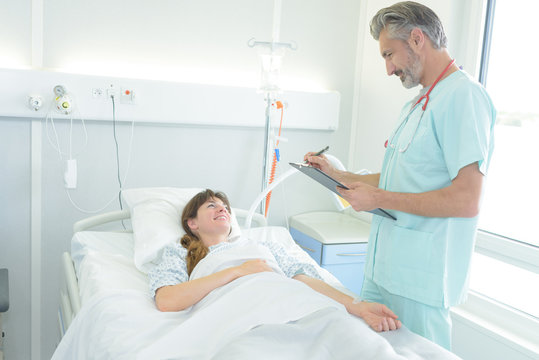 doctor visiting patient in hospital room