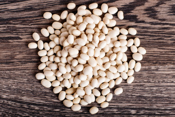 Pile of  white beans isolated on a gray wooden background.