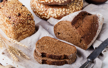 Fresh bread assortment on a textile background. Rustic background.