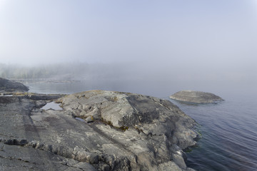 The shore of Lake Ladoga in dense fog. Karelia, Russia.