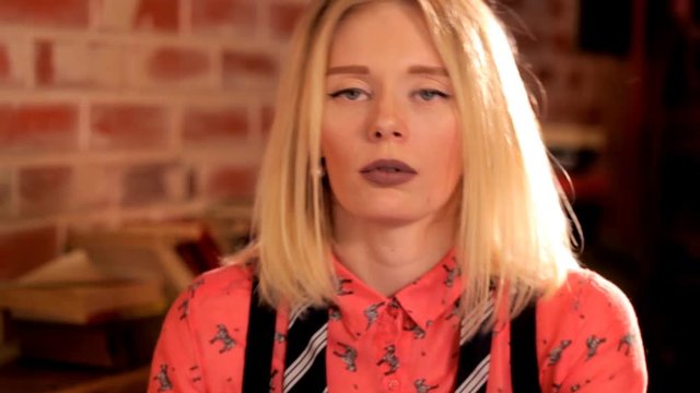 Artistic girl in the restaurant drinking a cocktail