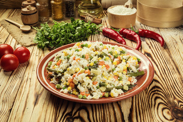 Colorful rice and vegetable salad,Bowl of pasta (orzo) or rice with vegetables,selective focus,Appetizing healthy rice with vegetables in plate on a wooden background,Delicious risotto with vegetables