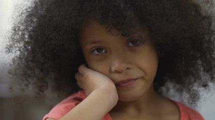 Beautiful Afro-American kid smiling at camera, positive emotions, closeup