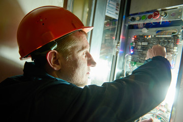 Electrician works with electronic equipment