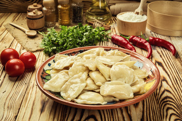 Vareniki (dumplings), pierogi - traditional Ukrainian food,Cooked and served vareniki,pyrohy or dumplings, filled with potato and served with salty caramelized onion,homemade