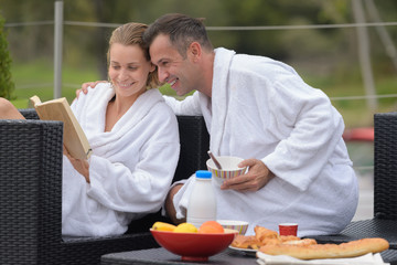 happy loving couple enjoying breakfast in cafe