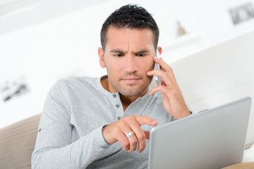 business man on phone and laptop in office