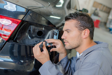 Mechanic looking at light connector