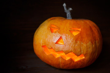 Halloween pumpkin head jack lantern on wooden background