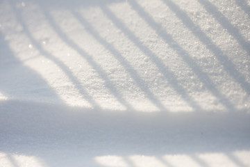 Snow texture with shadows - stripes from a fence
