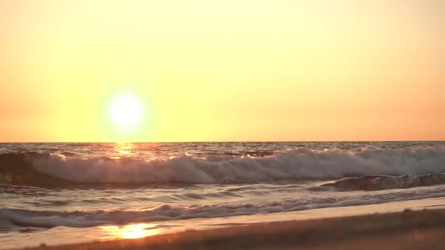 Aerial view of waves crashing on the beach at sunset, Video Shot in Sabaudia, a beautiful beach on the west coast of central Italy.