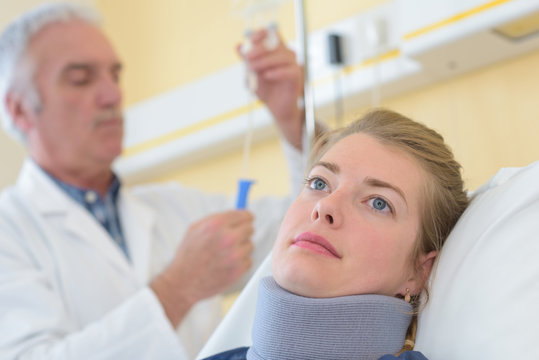woman in pain at the doctor for a neck injury