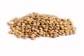 Pile of green lentils isolated on white background.