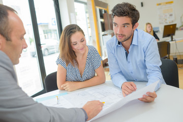 couple checking paperwork at an agency