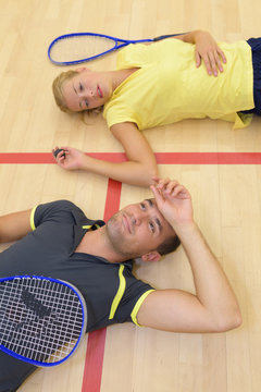 tennis couple resting in court after a match