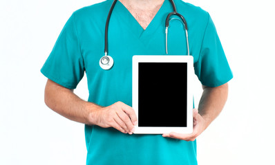 Doctor with stethoscope holding blank digital tablet