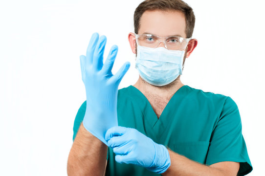 Male Doctor With Stethoscope And Protective Mask And Gloves.