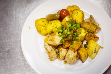 Meat dish with potatoes and tomato