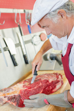 Butcher skilfully preparing a cut of beef