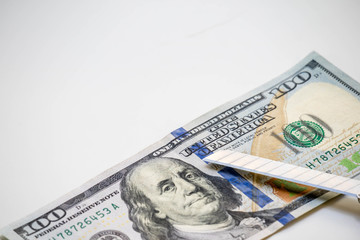 US Dollar cash banknote and cutter knife