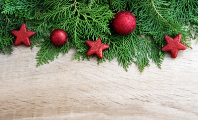  Pine leaf with red star and christmas ball decoration on  wooden board with copy space , happy new year and chistmas festival background concept