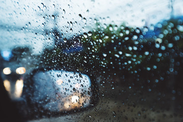 Rainy day on the road, Raindrops on car mirror with side wing mirror