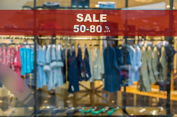 Fototapeta na wymiar Sale 50-80% off mock up advertise display frame setting over the Abstract blurred photo of clothing store in a shopping mall, shopping concept