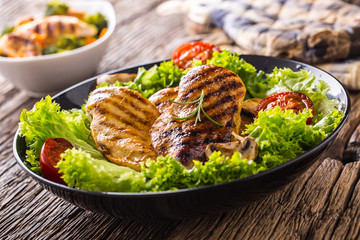 Grill Chicken Breast. Roasted and grill chicken breast with lettuce salad tomatoes and mushrooms