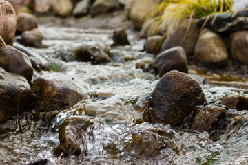 water flowing down a stream over rocks