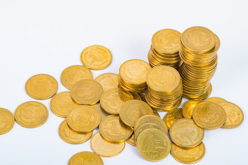 Columns of gold coins, piles of coins on white background