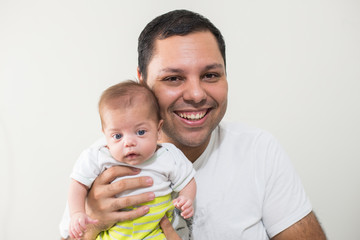 Father holding blue eyed baby - Side by side