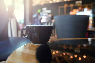 abstract  hot coffee in coffee shop with wooden table background.