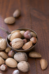 Nuts mix in a metallic bowl on the wooden table