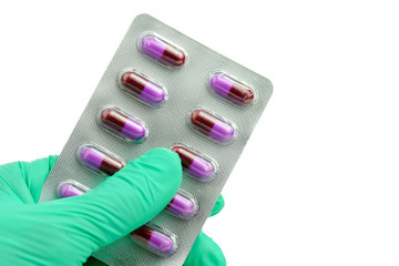 hand holding panel antibiotic drug capsule on white background