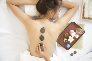 Obraz na płótnie Canvas Spa concept.Stone Massage on back relaxation for beautiful woman.