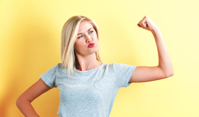 Fototapeta premium Powerful young woman on a yellow background