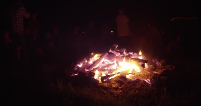 Group of friedns surround bonfire - timelapse