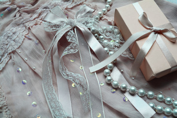 gifts for women, festive wrapped gift on lace fabric with pearls and embroidery