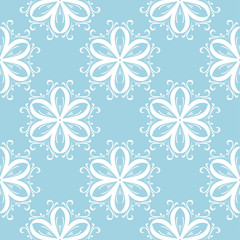 Fototapeta premium White flowers on blue background. Ornamental seamless pattern
