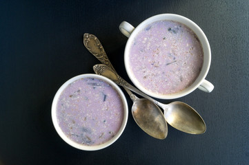 Soup of red cabbage on a black background.