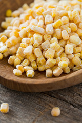 frozen sweet corn on woode surface